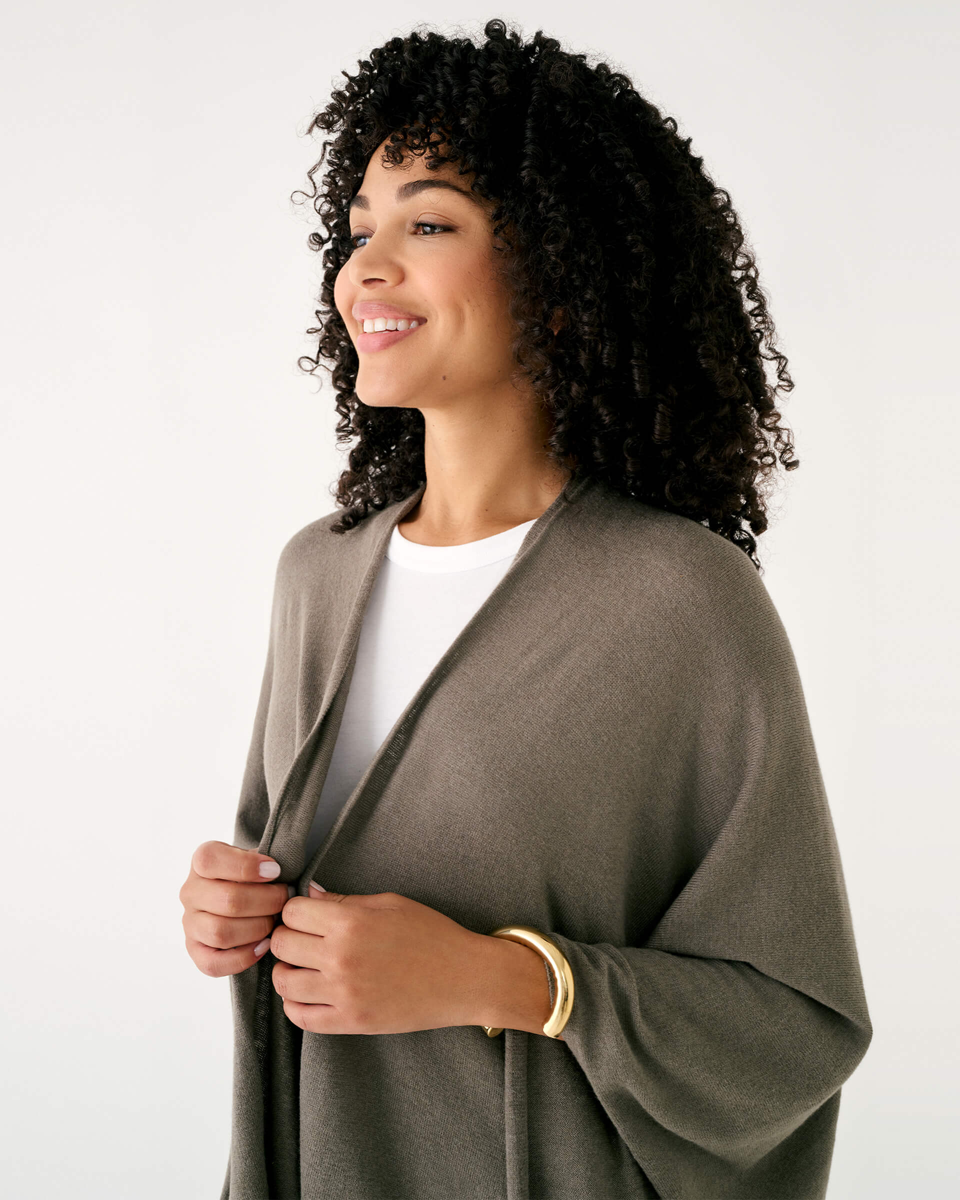 closeup of woman wearing mersea brown charleston cotton cashmere wrap standing on a white background