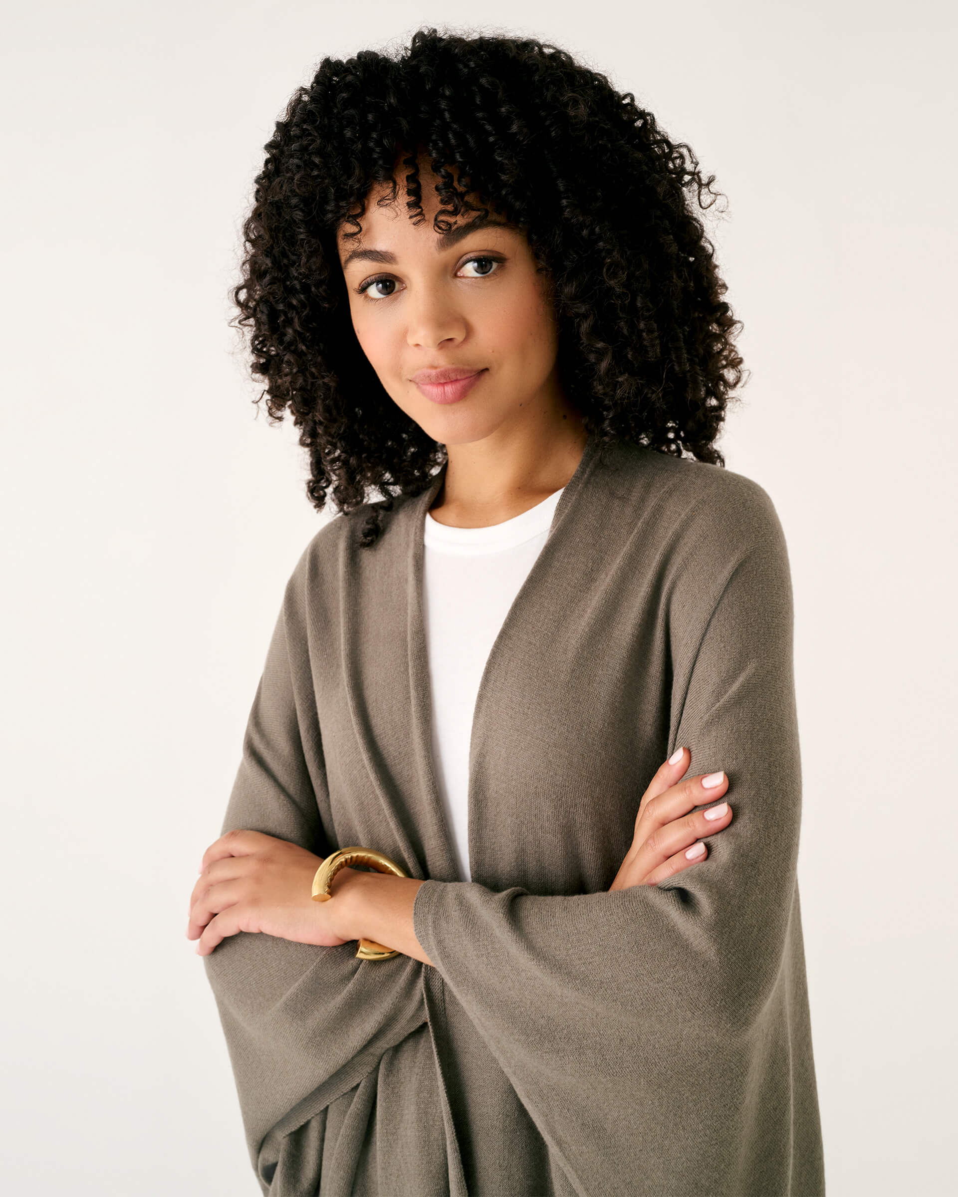 closeup of woman wearing mersea brown charleston cotton cashmere wrap standing on a white background