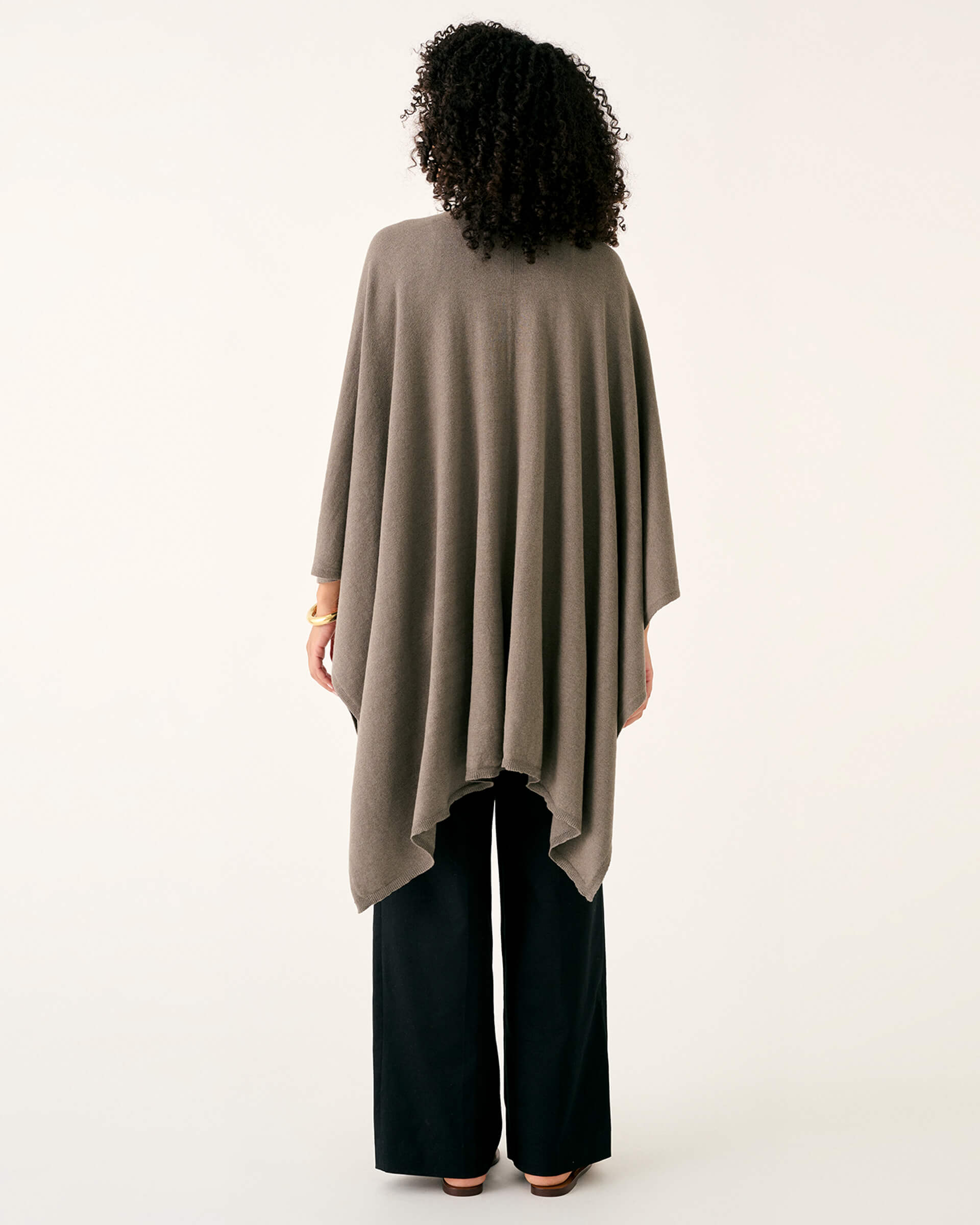 rearview of woman wearing mersea brown charleston cotton cashmere wrap standing on a white background