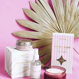 Coconut sugar product collection of candles, diffuser and room spray in front of pink background