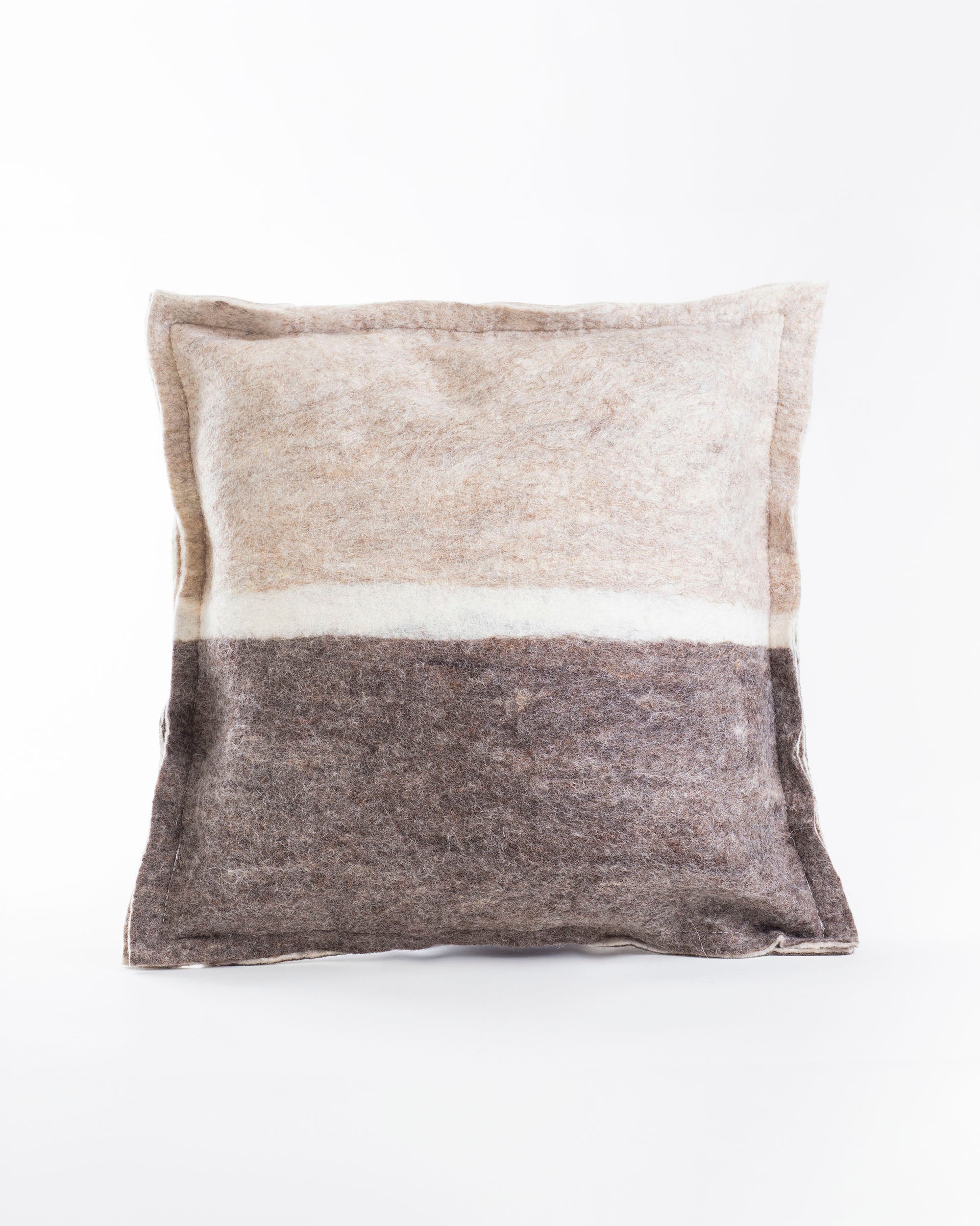 neutral and grey felt wool pillow with a white line across the middle sitting on a white background