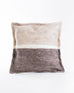 neutral and grey felt wool pillow with a white line across the middle sitting on a white background