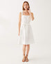 female wearing white A-line linen sundress with self-belt standing on a white background