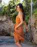 female wearing clay A-line linen sundress with self-belt walking down the street