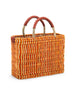 orange and beige small striped basket with red leather handles on a white background