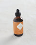 small bottle of orangerie scented oil burner with orange marrakesh label on white background