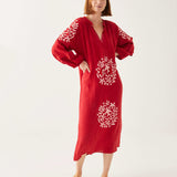 female wearing red and white embroidered maxi dress with tassel ties on a white background