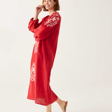female wearing red and white embroidered maxi dress with tassel ties on a white background