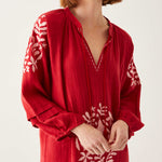 female wearing red and white embroidered maxi dress with tassel ties on a white background
