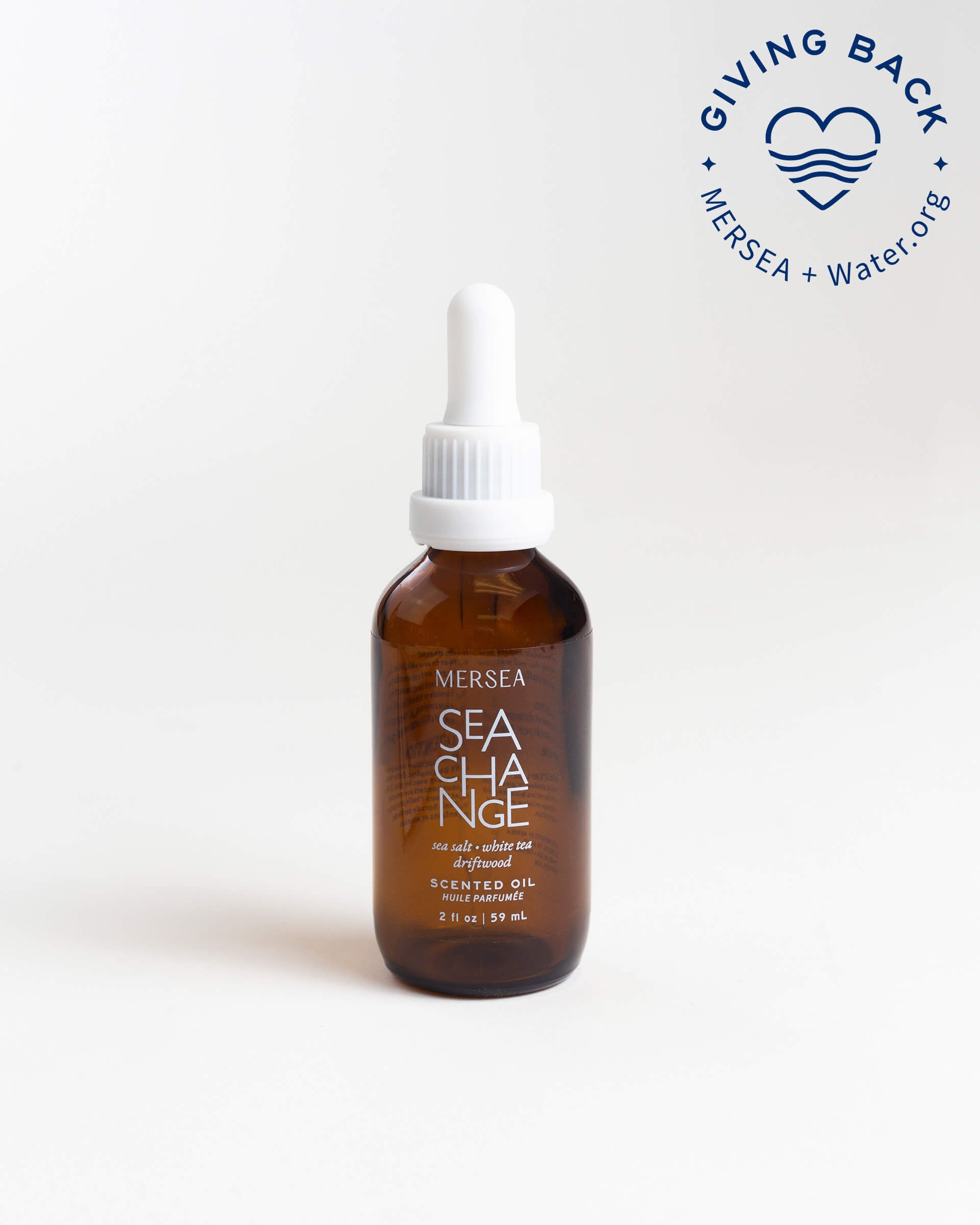 small bottle of sea change scented oil on a white background