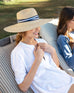 woman wearing Sunshine Wide Brim Hat while sunbathing