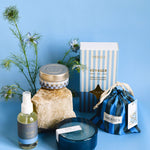 voyageur product collection of candles, diffusers and room sprays in front of blue background