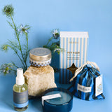 voyageur product collection of candles, diffusers and room sprays in front of blue background