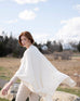 Red hair girl wearing a Carmel wrap with cable knit details